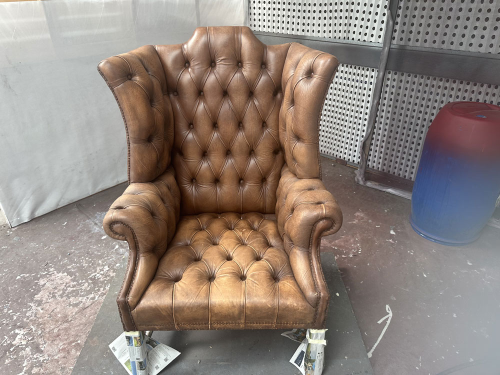 old wing-back leather chair before