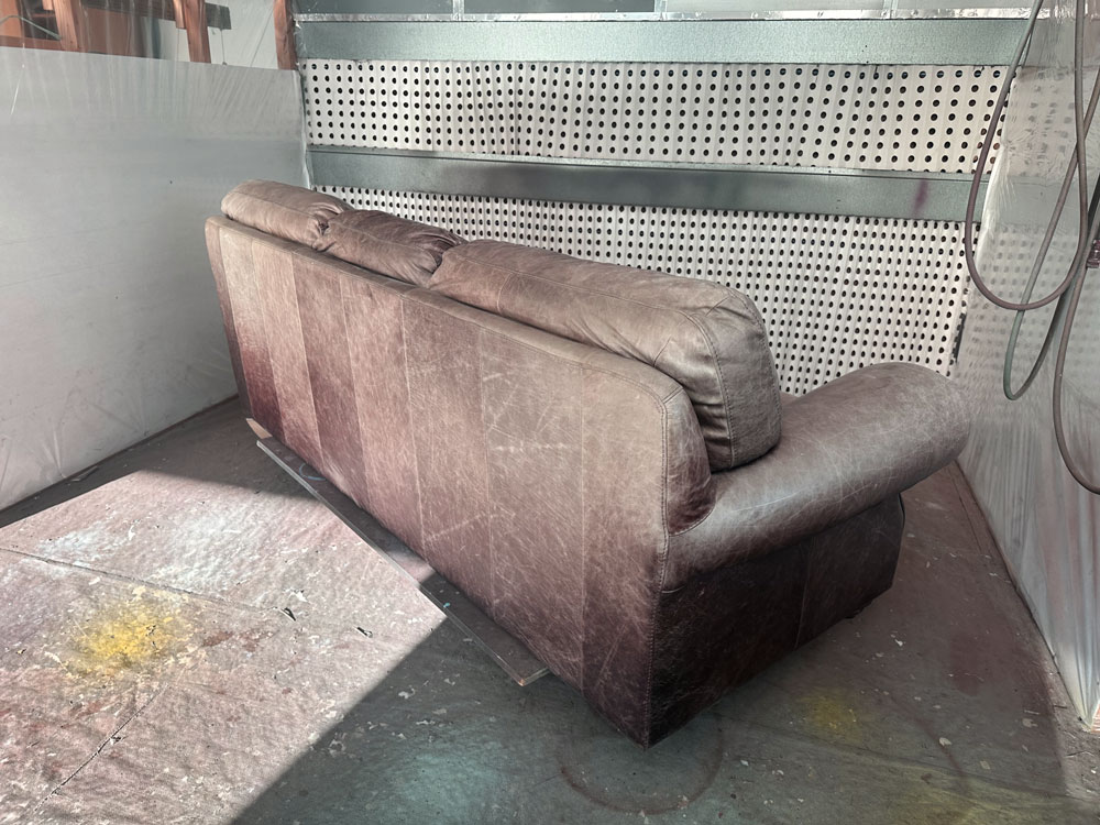 Outside back of faded waxed oiled couch
