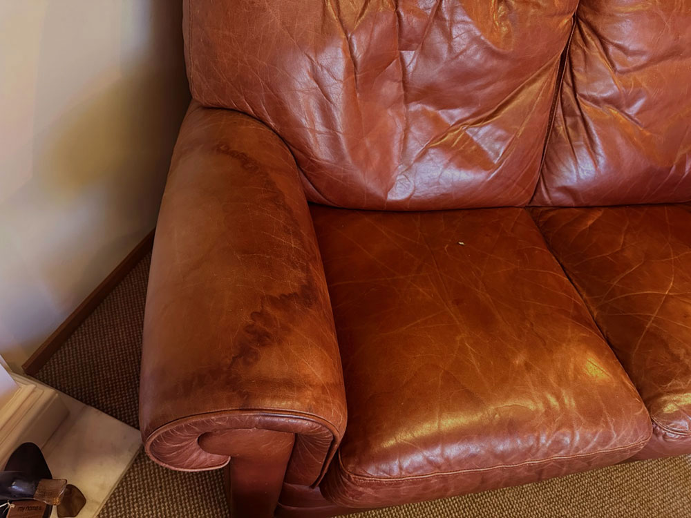water stained leather couch before