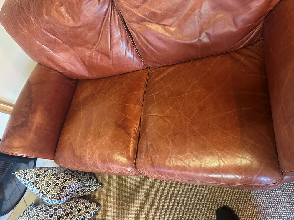 water stained leather couch before